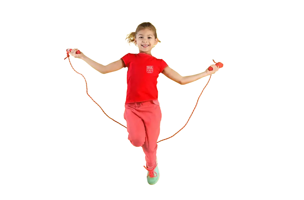 Ein fröhliches Mädchen springt mit einem Seil, das für die Turngemeinde Landshut trainiert.