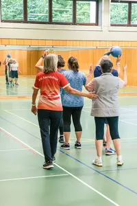 Eine Gruppe älterer Frauen trainiert in der Turnhalle des Vereins TG Landshut mit Gymnastikbällen.