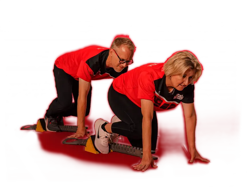 Zwei Personen in Sportkleidung der Turngemeinde Landshut starten synchron auf roten Startblöcken.
