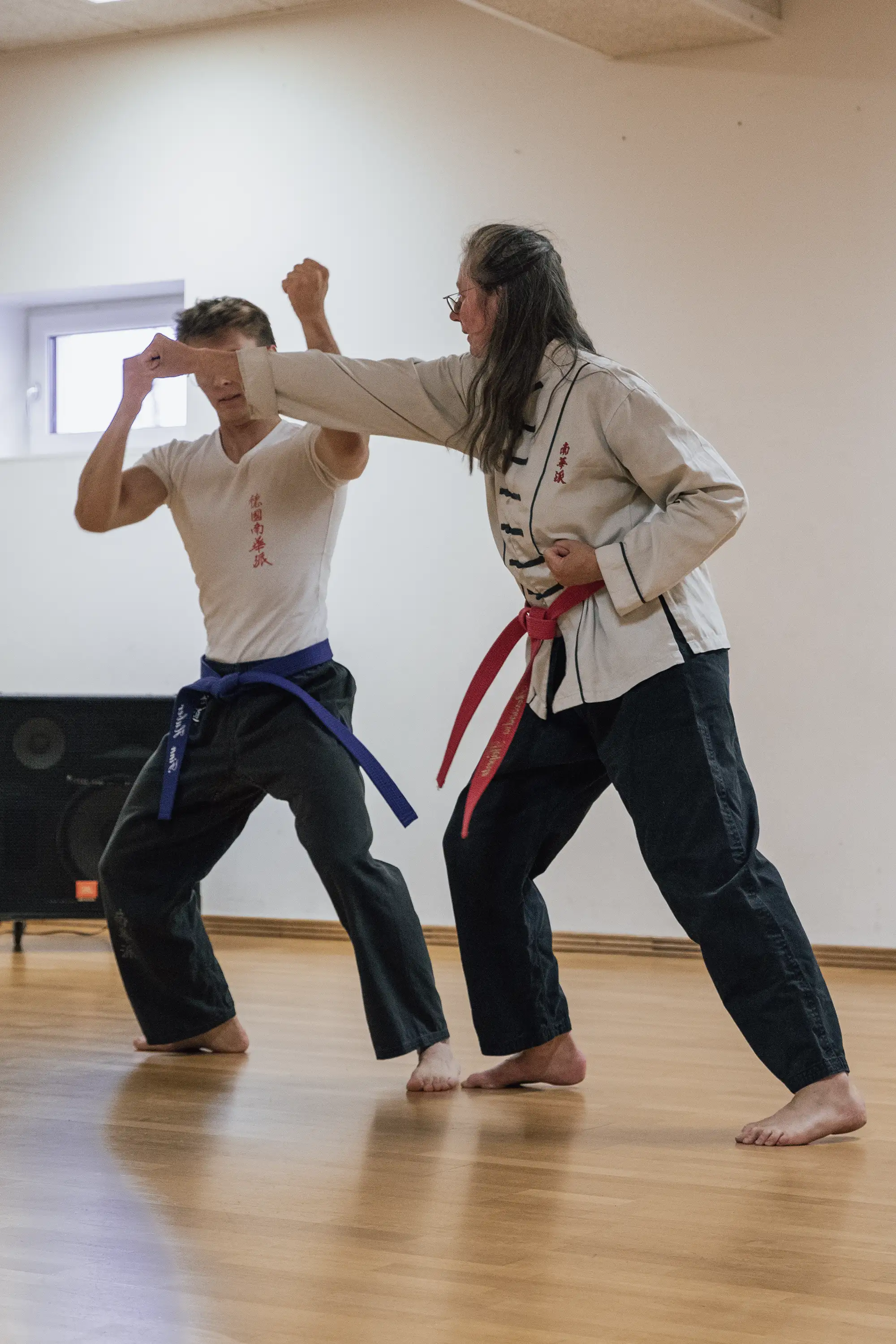 Zwei Personen üben Kampfkunst im Trainingsraum des Turngemeinde Landshut Vereins.